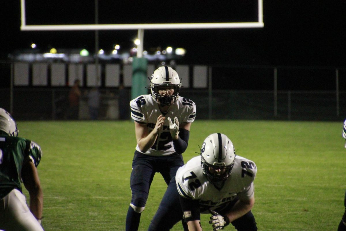 Center Ethan Stitt snaps the ball to Quarterback Zachary Bates at James Buchanan for the first, and only, win of the season.