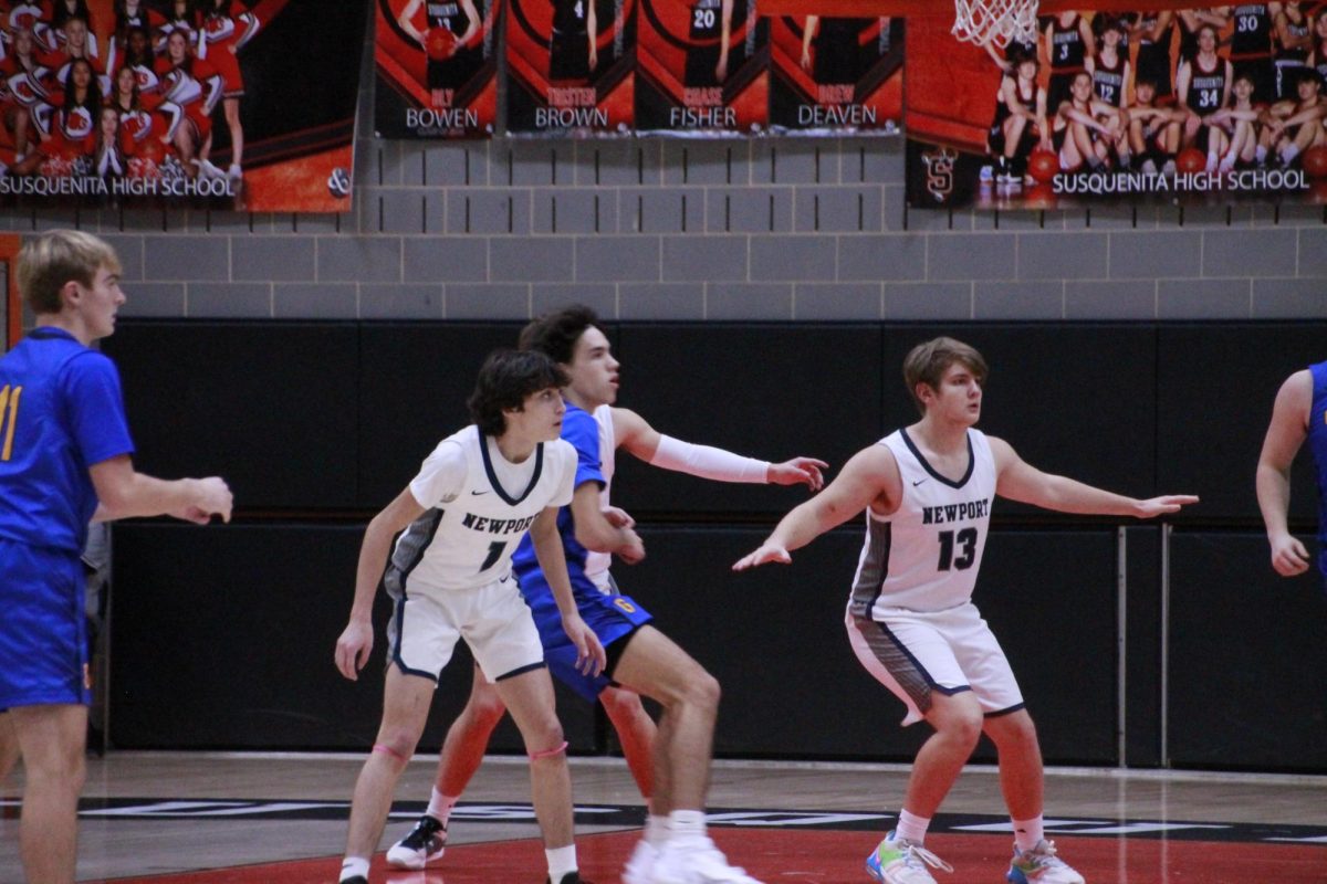 Newport defends against Greenwood in the paint in the first round of the PeCo tournament.