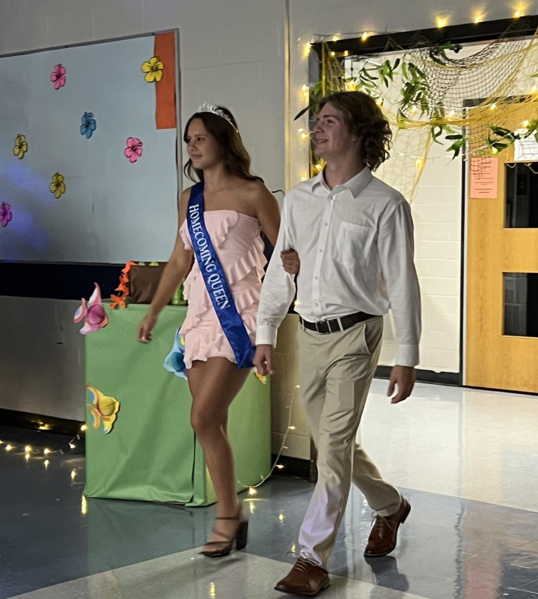 Homecoming Queen Pace Smith-Robbins walks with Homecoming King Bryan Schue