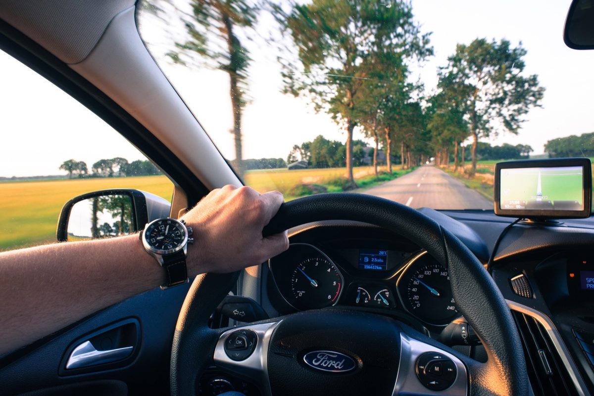 Man driving down a rural road