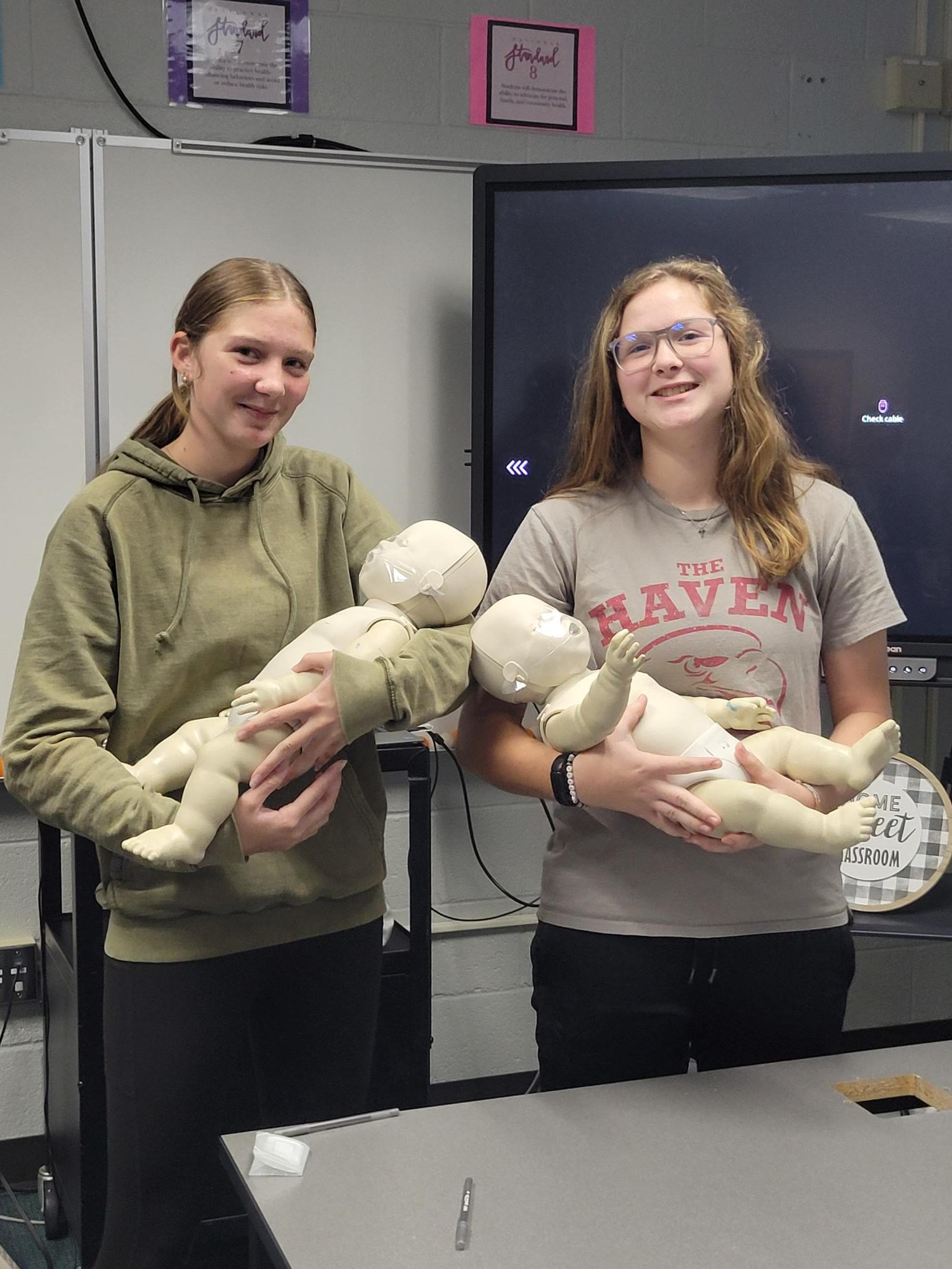Sophomore Gabriella Benner and freshman Eliza Benner at the CPR training course