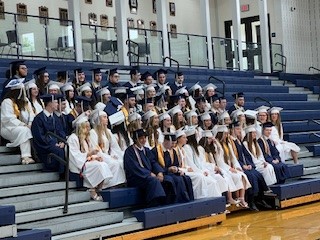 It's getting real! Seniors take their final graduation picture decked in their caps and gowns.