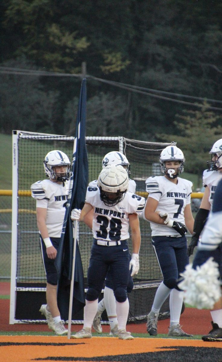 Dalton Kratzer prepares to run the Buffalo flag at last years game at Susquenita.