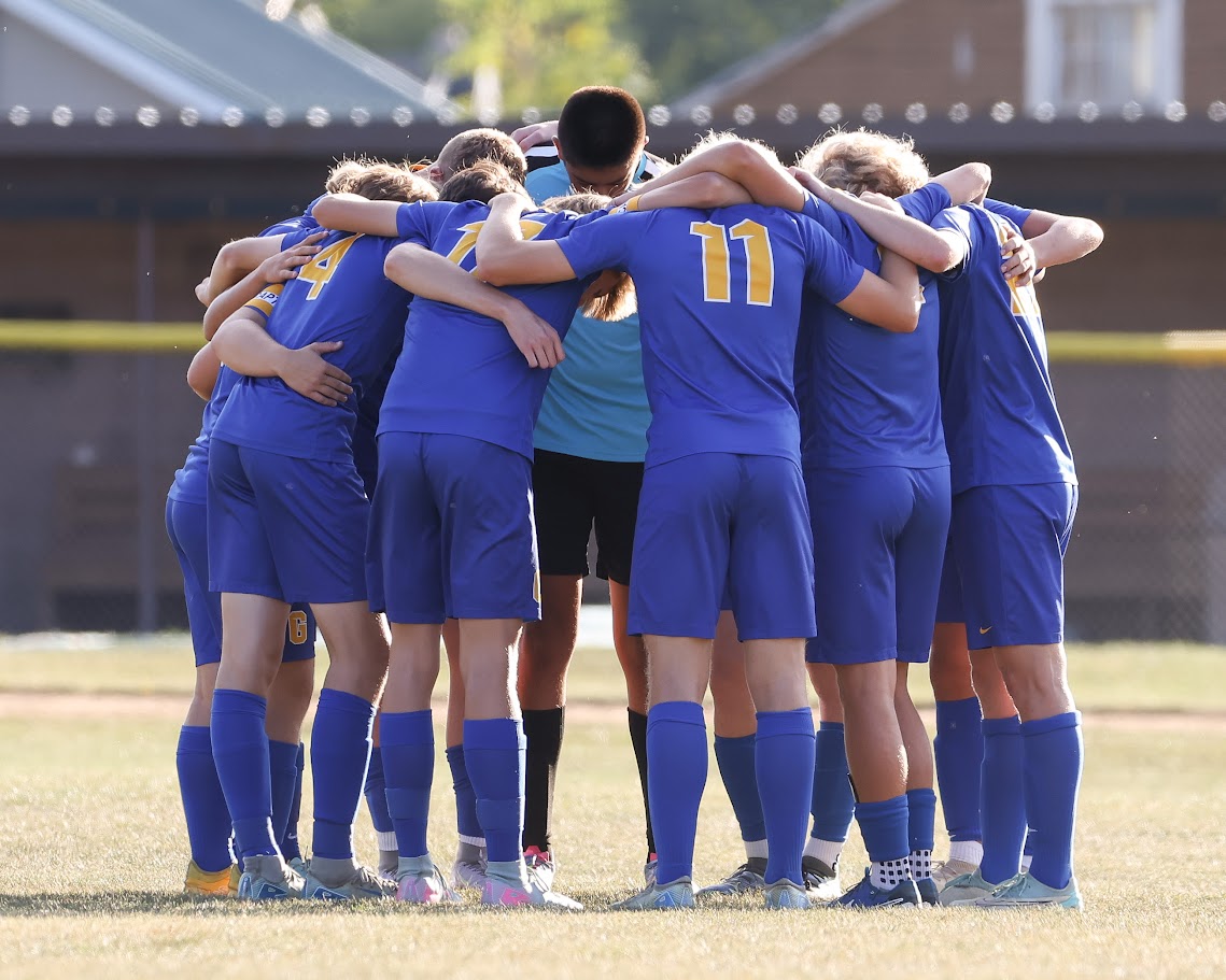 The Varsity starters huddle prior to the Tri-Valley game.
