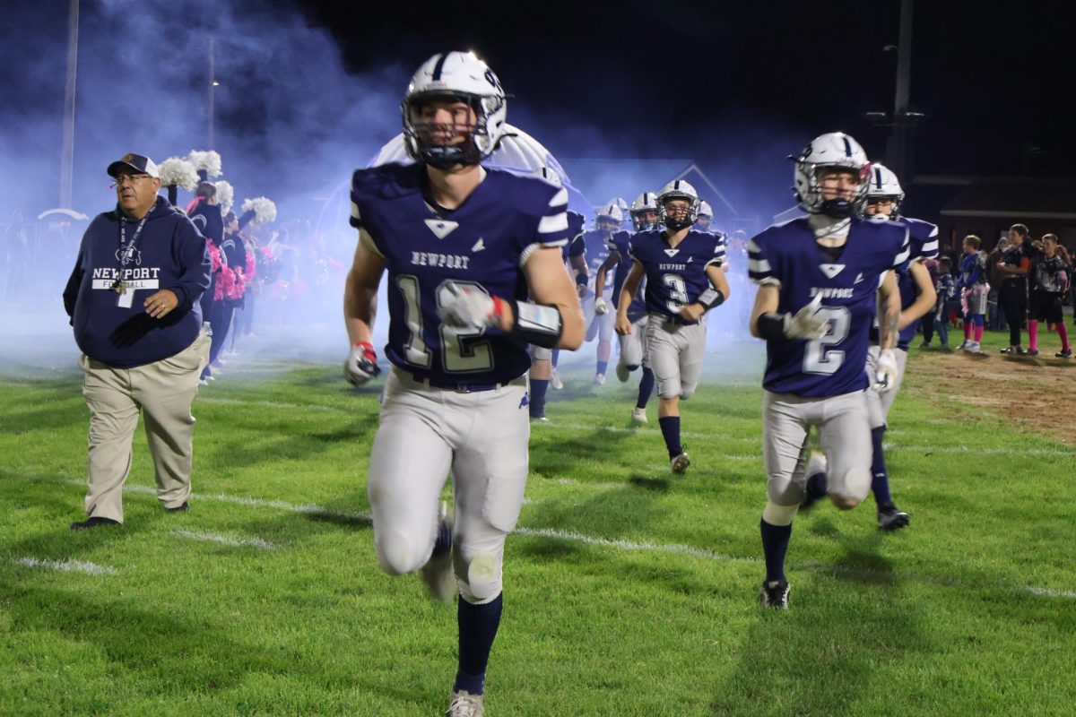 The football team rushing through fog for their Homecoming football game entrance