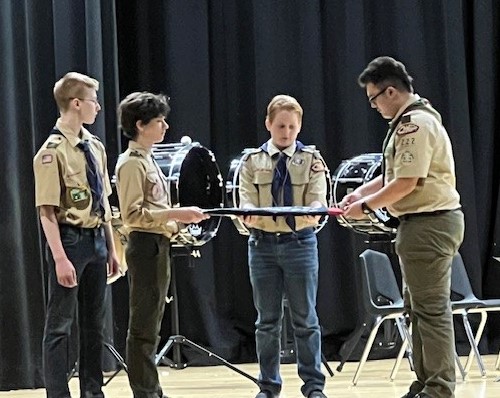 Scouts from Newport's Boy Scout Troop demonstrated the correct way to fold a flag during the Veterans Day Assembly on Nov. 11, 2025