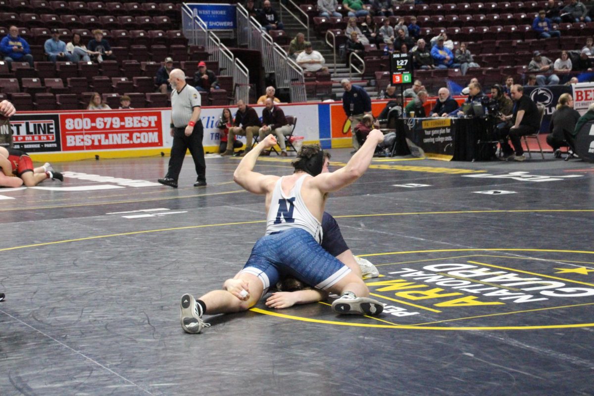 Senior Kaj Miller celebrates his takedown in his quarterfinal match at the PIAA State Wrestling Championships at the GIANT Center on Mar. 6. Miller would go on to place 5th at 215 lbs.